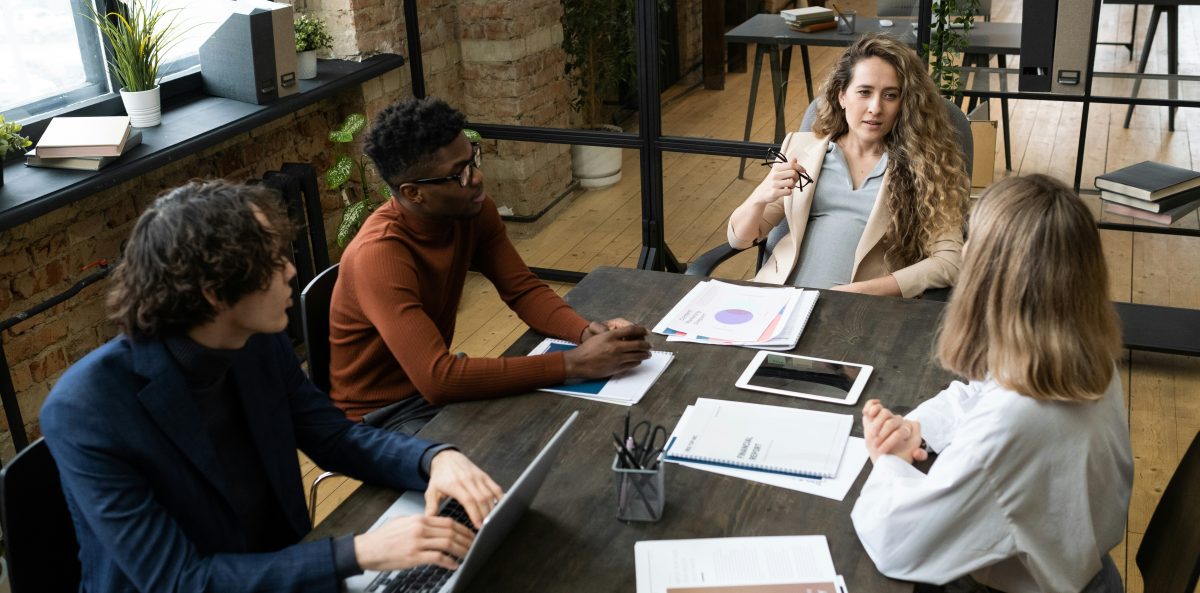 A leadership team engaged in an intentional, face to face conversation, reflecting the three critical discussions nonprofit leaders should have before the new year begins.