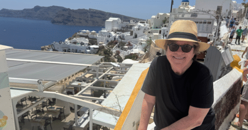 Joan Garry poses with a vacation backdrop to demonstrate proof that there was at least one day on her vacation when she did not work.