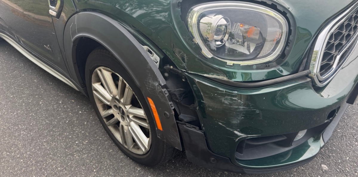 Joan’s damaged car after the collision, symbolizing the hidden cost of moving too fast.